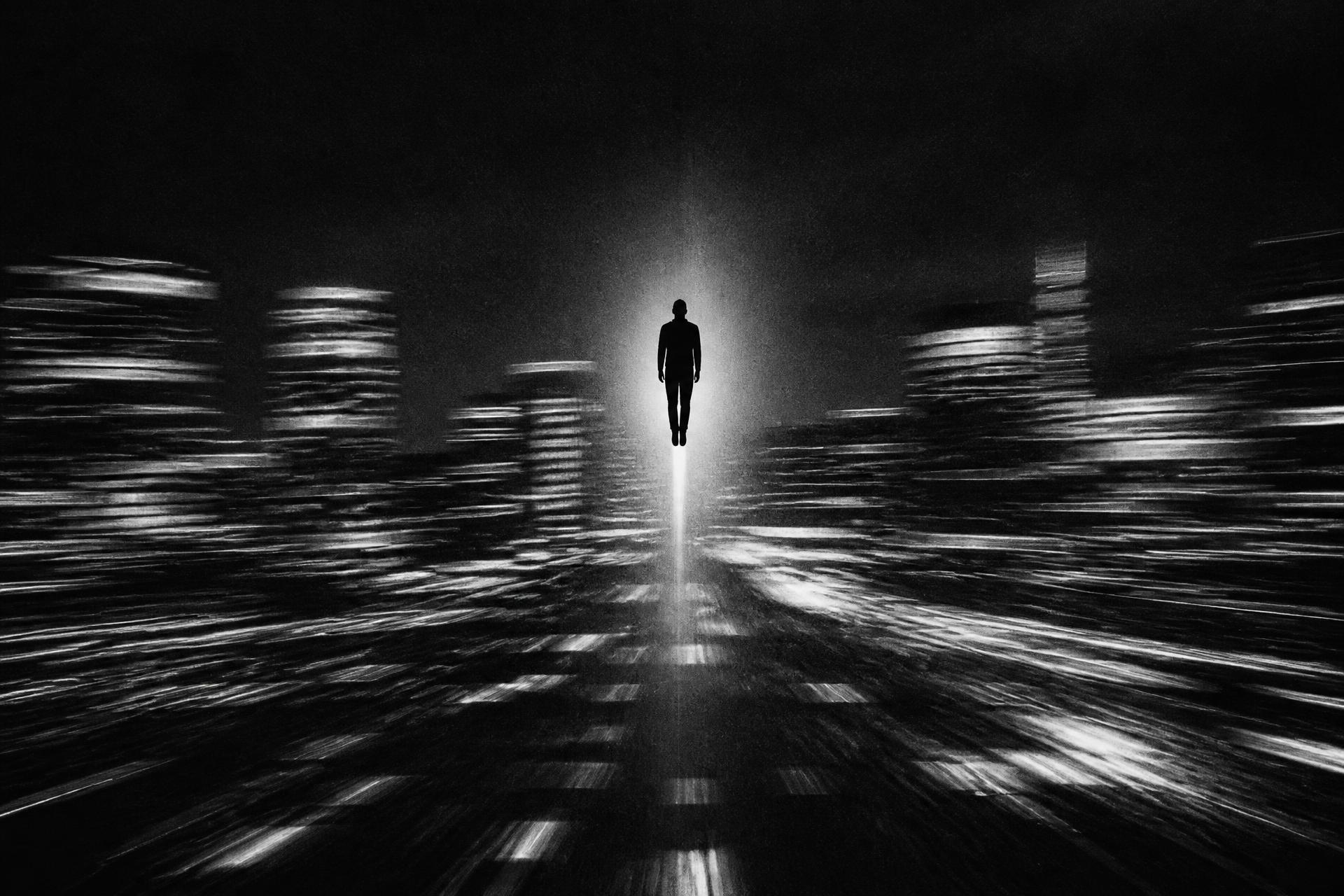 A blurred night city racing past a single sharp silhouette rising upward